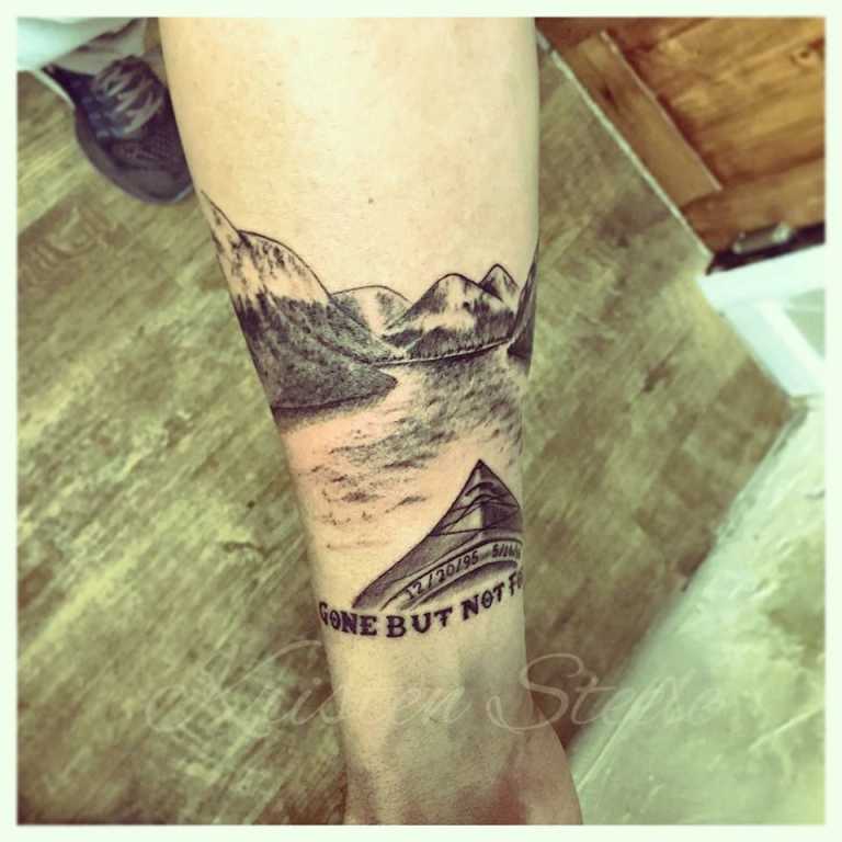 Mountain and kayak scene, memorial tattoo (in progress) by Kristen