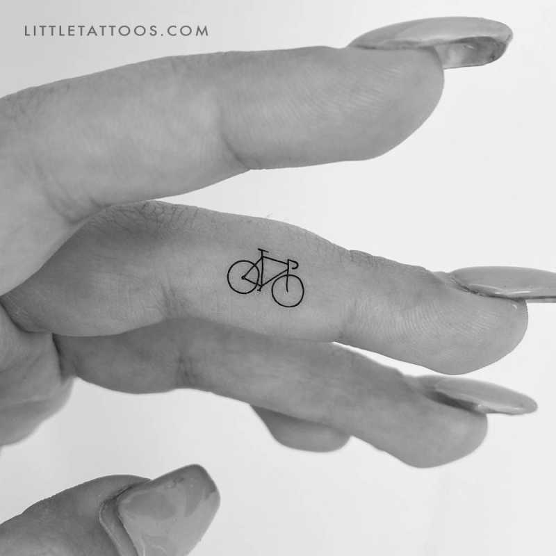 Small minimalistic bike temporary tattoo located on the